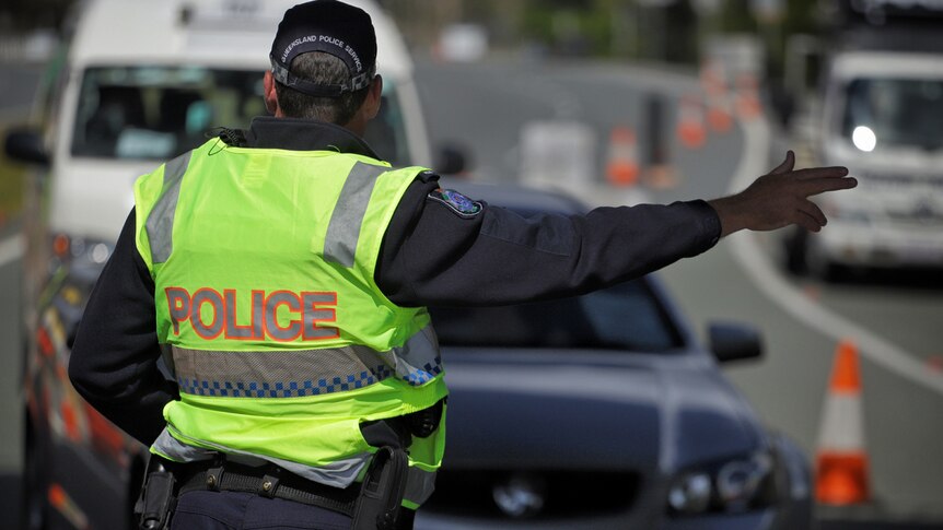 Police direct traffic at the at the Queensland border checkpoint on the Gold Coast Highway at Bilinga on August 26, 2020.