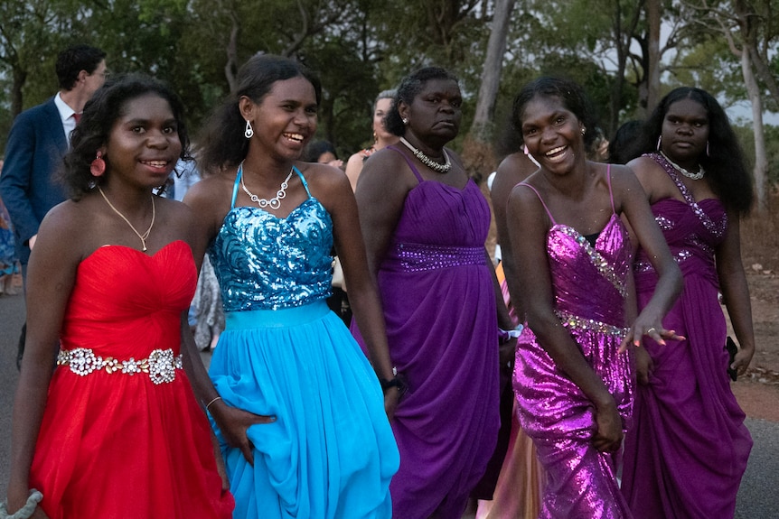 young women in formal dresses laughing
