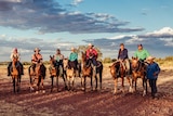 Ten stockmen and women and their horses at Mistake Creek WA.