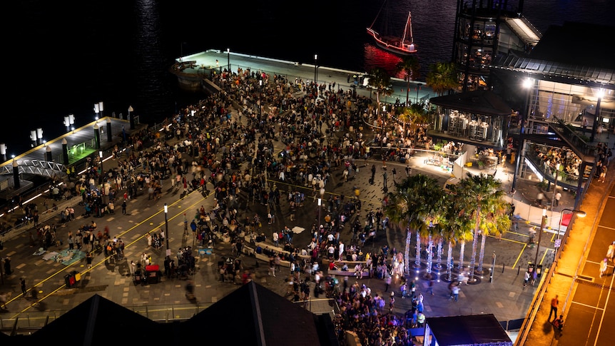 A bird's eye view of a crowd of people leaving after the midnight fireworks finished.