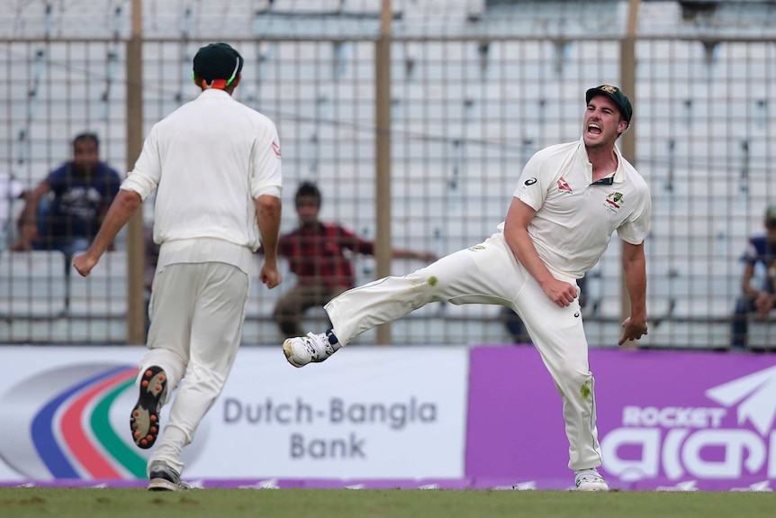 Australia's Pat Cummins celebrates taking a catch against Bangladesh