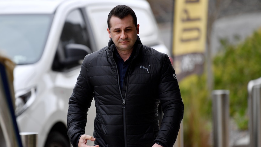 a man walking on along a footpath