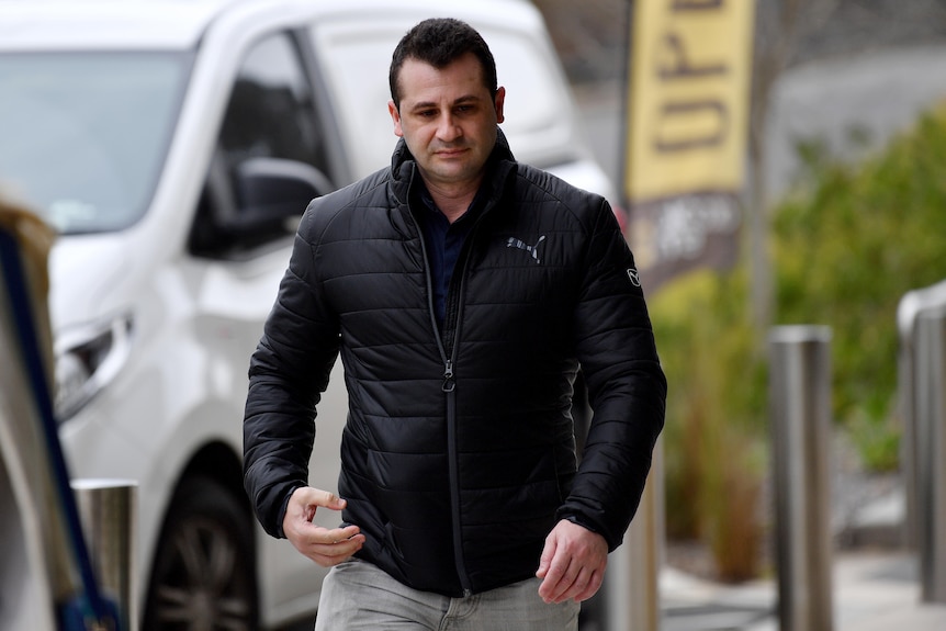 a man walking on along a footpath