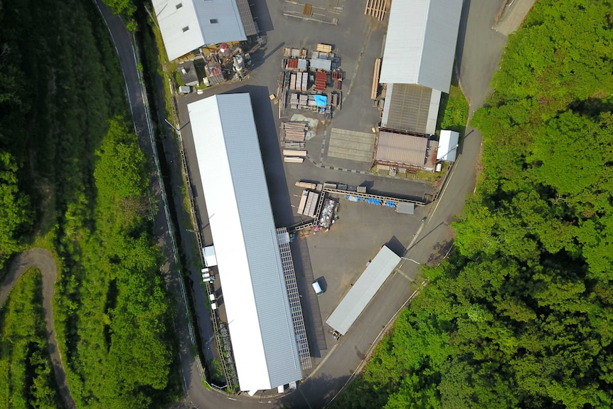 Looking down at the long shed rooves of the recycling plant