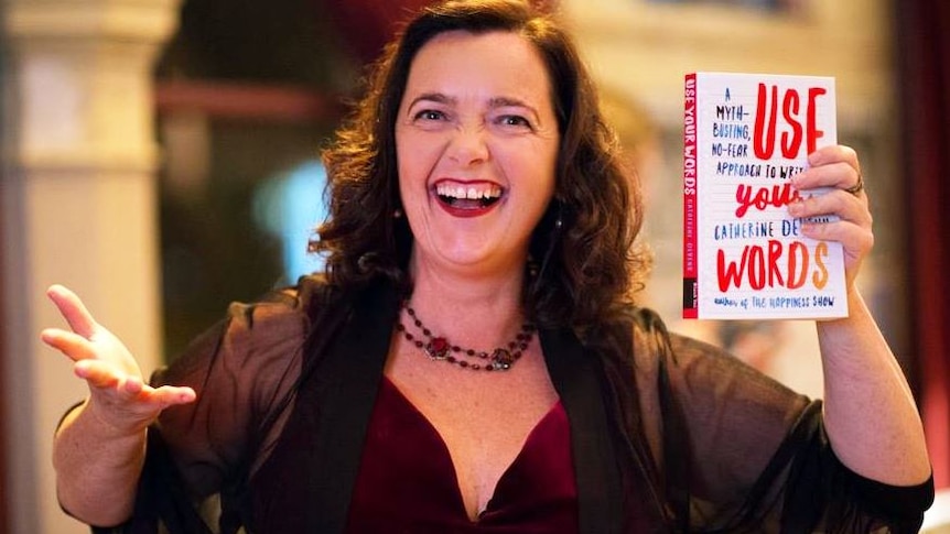 Writer and proud dyslexic Catherine Deveny holds up her ninth published book, Use Your Words.