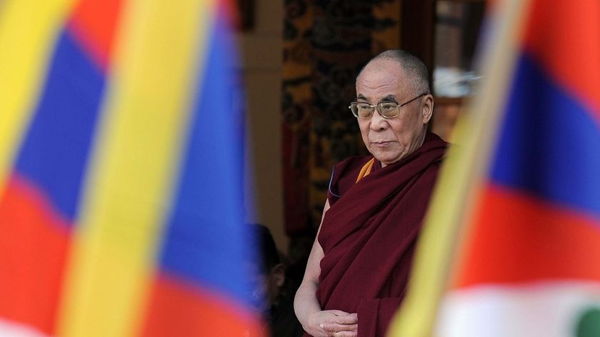 Semi-retired: the Dalai Lama offers prayers at his palace temple