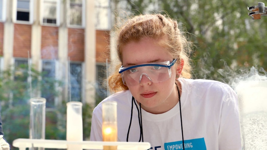 Anna Dallmann, National Youth Science Forum attendee, performs an experiment at the ANU.