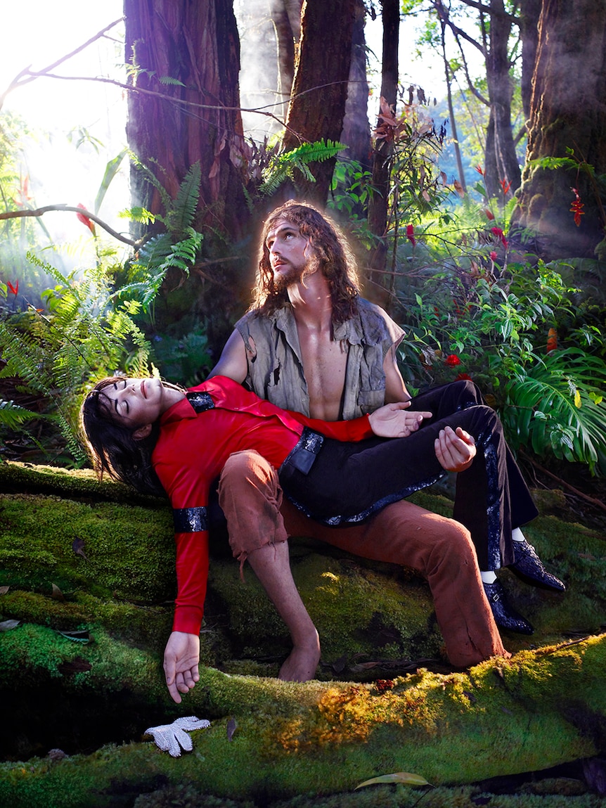 Jesus holds Michael Jackson in a rainforest