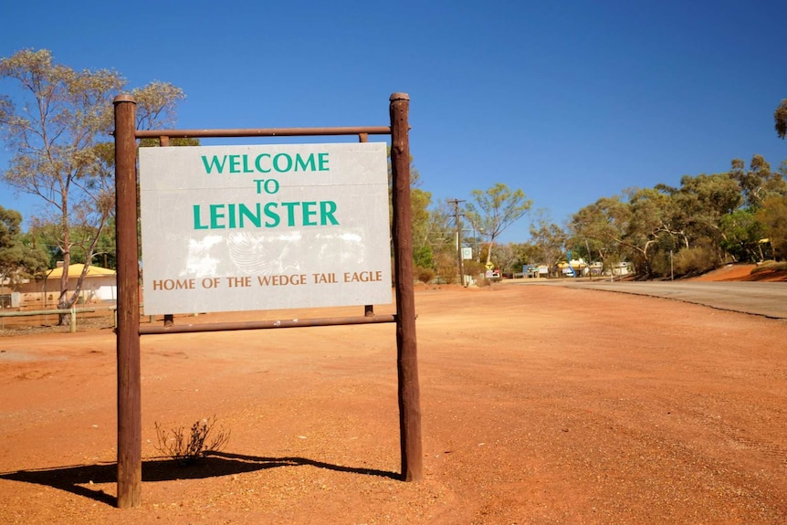 A sign on the side of a road that reads "Welcome to Leinster, home of the wedge tail eagle'".