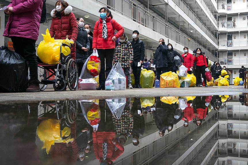 A line of Chinese people in face masks