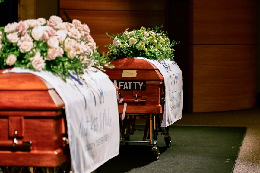 A casket with flowers reads "Fatty".