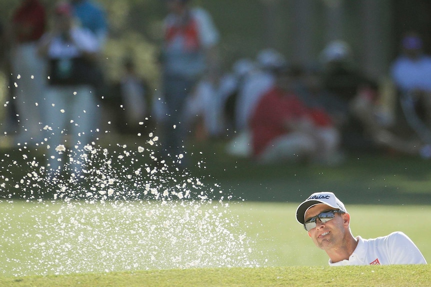 Adam Scott hits from a bunker on the 17th hole during his final round at Augusta National.