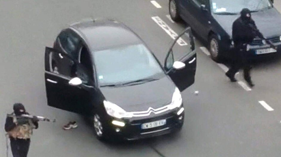 Two gunmen outside the offices of satirical newspaper Charlie Hebdo in Paris.