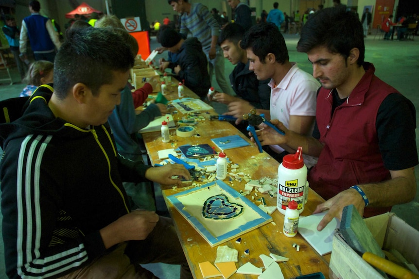 Asylum seekers making mosaics