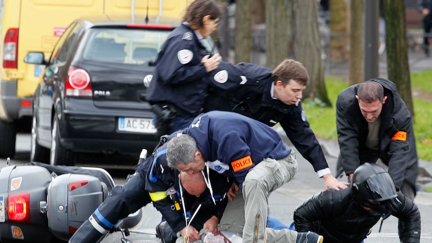 French police hold down and handcuff people outside kosher supermarket