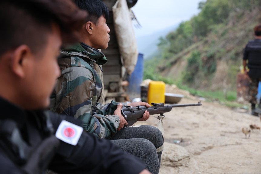 A young soldier with a gun.