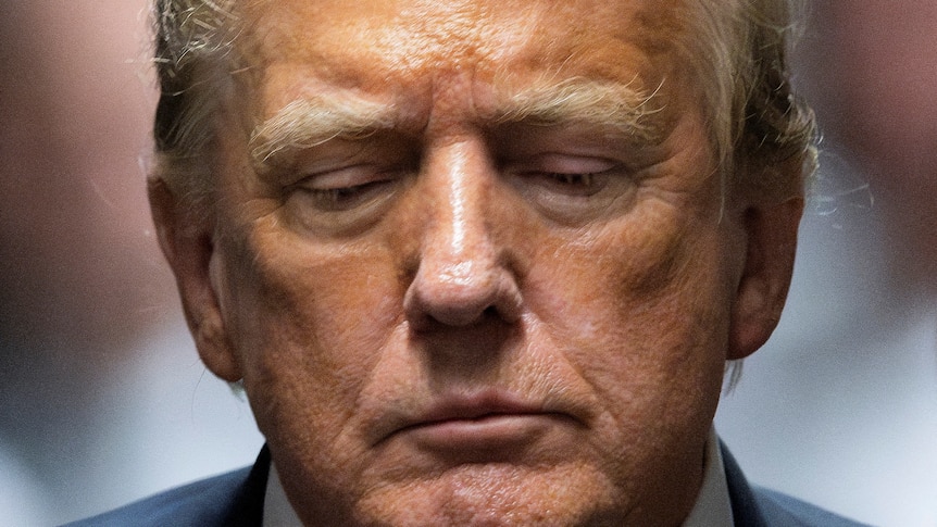 A tight close-up of Donald Trump's face, as he looks down.