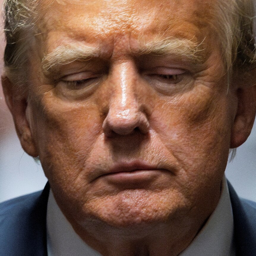 A tight close-up of Donald Trump's face, as he looks down.