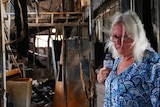 A woman at the site of a house fire.