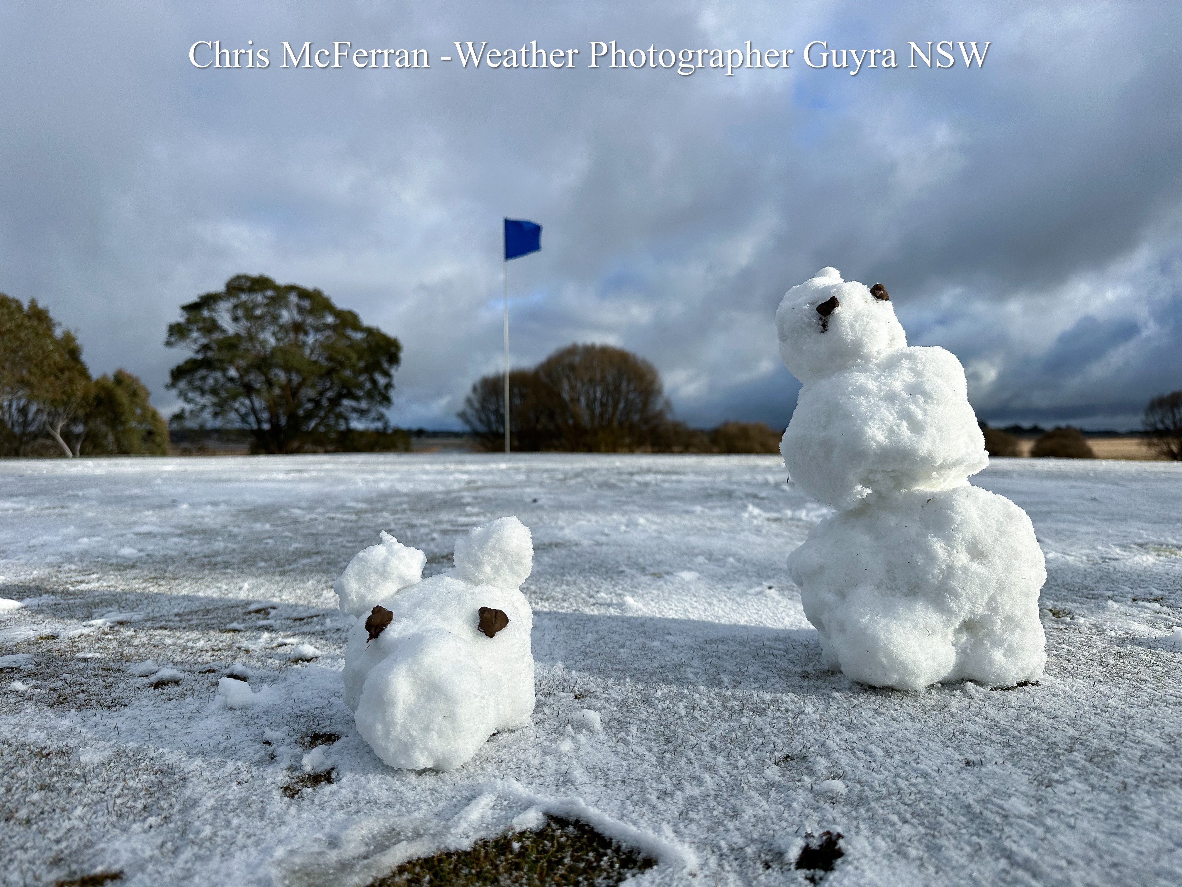 Two small snowmen made from sleet on a car park ground in Guyra New Suoth Wales 