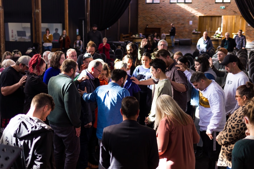 group of people praying at church