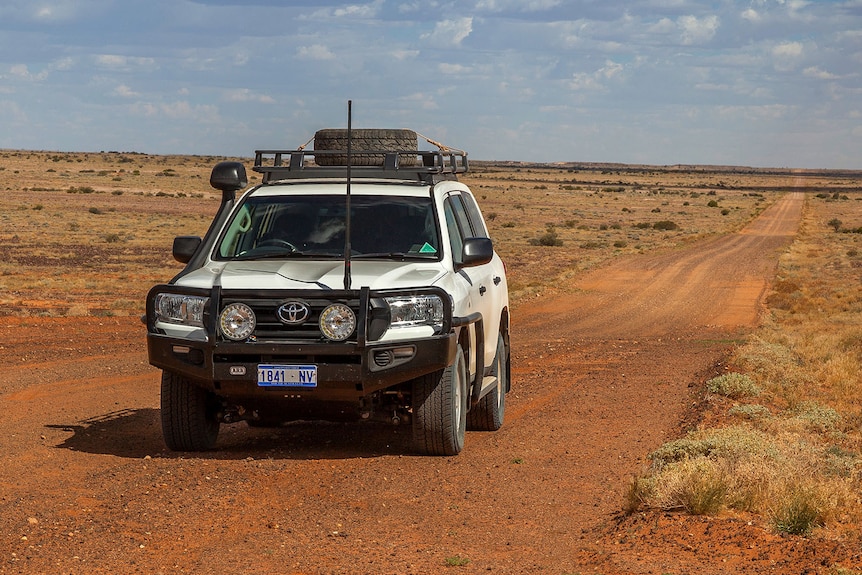 Car drives in outback