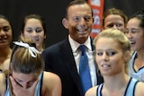 Tony Abbott poses with netballers at Olympic Park.
