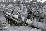 An historic photograph of a water pipeline being built.