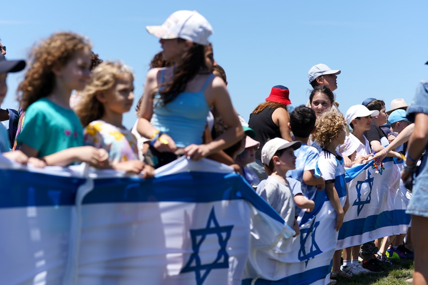 Children hold flags at a park