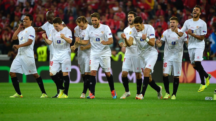 Sevilla celebrates during shootout