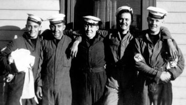 A historical photo of five seamen relaxed and smiling.