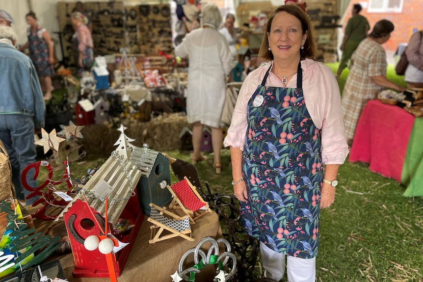 Photo of a woman wearing an apron at a crafts store.