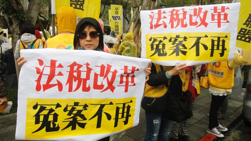 Protesters hold slogans reading "Tax Reform. No more Miscarriage of Justice" outside of Ministry of Finance in Taipei, Taiwan.