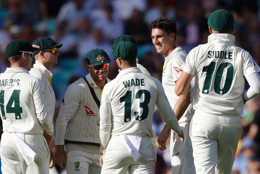 A bowler and his teammates celebrate a wicket in an Ashes Test.
