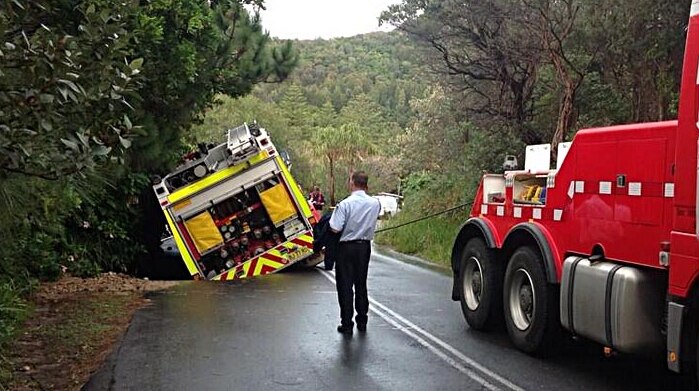 A fire engine sits in a sinkhole at Bilgola on Sydney's northern beaches.
