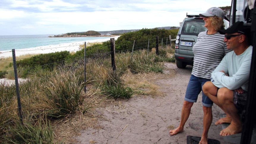 Lyn and Allan Thomas camping in their caravan beside Swimcart Beach at Tasmania's Bay of Fires Conservation Area