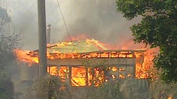 Mopping up: The fires yesterday destroyed seven houses.