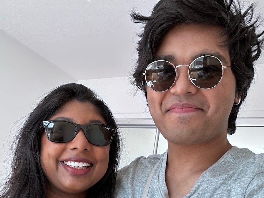 A couple with sunglasses posing for a photo