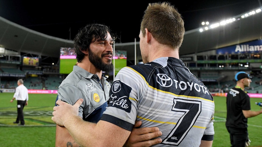 Johnathan Thurston congratulates Michael Morgan (R) after the Cowboys beat the Roosters in Sydney.