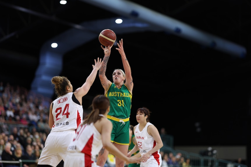 Cayla George jumps and is shooting the ball. 