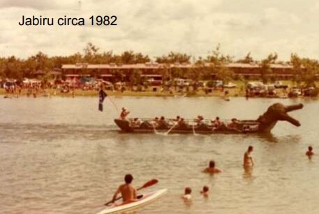 An old photograph of residents swimming, kayaking and riding a crocodile-themed boat in the Jabiru lake.
