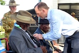 Prime Minister Tony Abbott presents a medal to Torres Strait veteran Bamia Mast