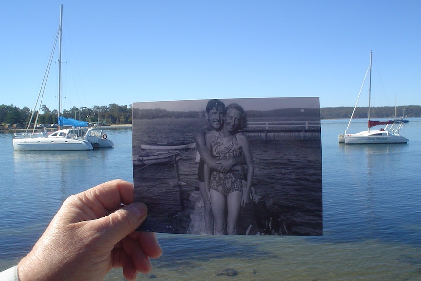 Foreground: Black and white photo of a couple standing at a pool. Background: The Clyde River Batemans Bay