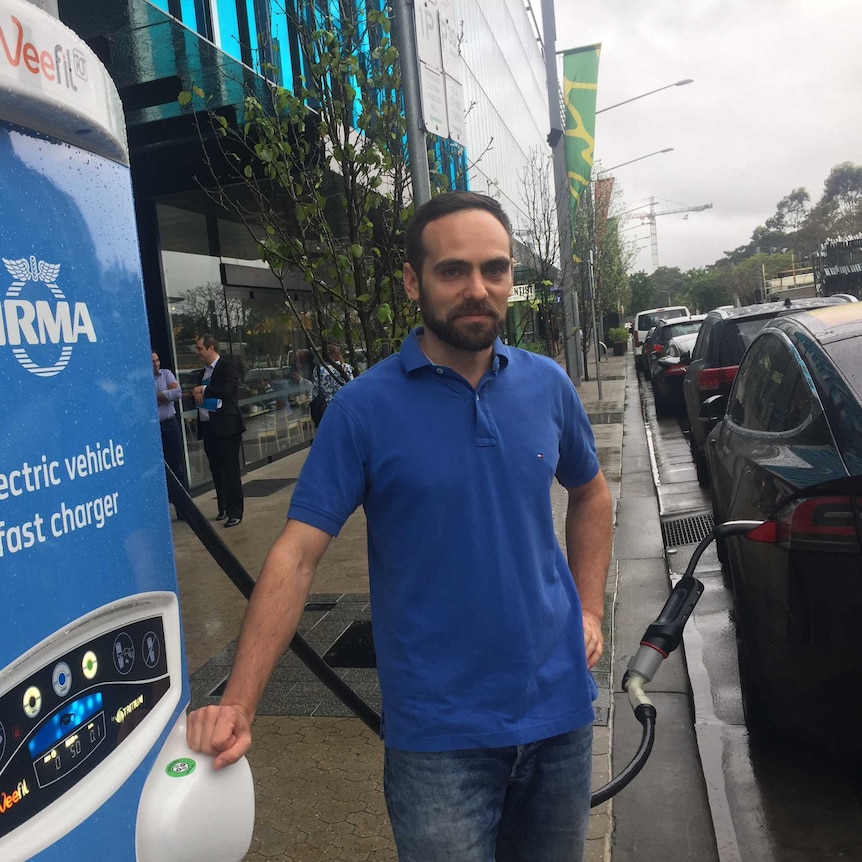 Man getting his car charged.