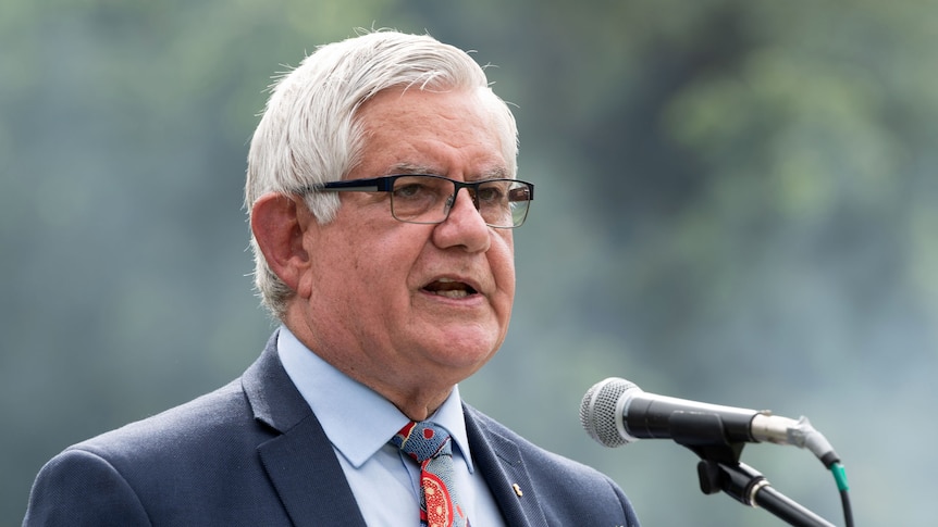 Headshot of Ken Wyatt at a microphone