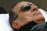 Hosni Mubarak is wheeled on a stretcher into court for his murder trial