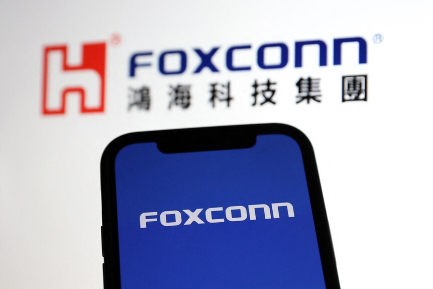 Foxconn logos are displayed on an Apple iPhone
