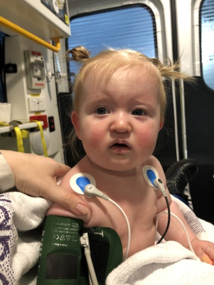 A toddler inside an ambulance.