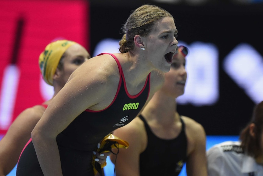 Shayna Jack shouts as she watches relay teammates race in the pool