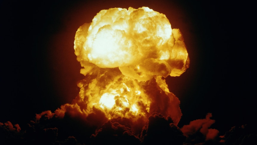 A photo of a mushroom cloud, with a bright yellow explosion.